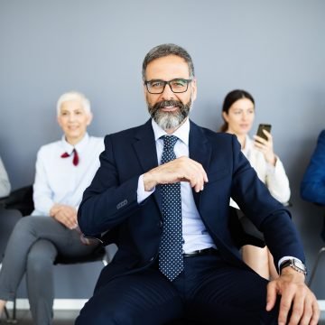 Group of business people with senior leader at front